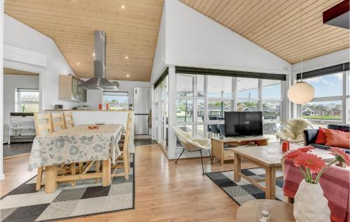 a kitchen and living room with a table and a dining room at Three-Bedroom Holiday Home Nordborg With A Room Hot Tub 01 in Nordborg