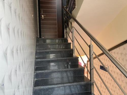 a staircase leading up to a stair case in a building at Hotel Sai viraj palace in Shirdi