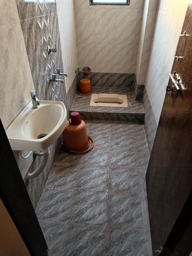 a bathroom with a sink and a toilet in it at Hotel Sai viraj palace in Shirdi