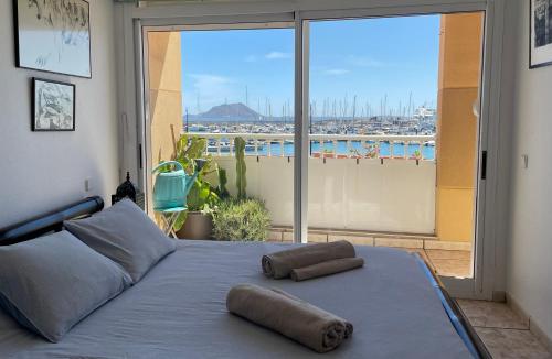a bedroom with a bed with two pillows on it at La Bocayna Vistas 3 Islas in Corralejo