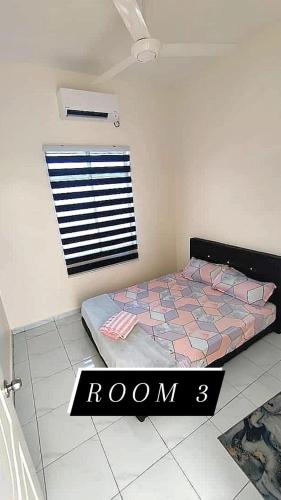 a bedroom with a bed in a room with a window at Az HOMESTAY PENDANG KEDAH in Pendang