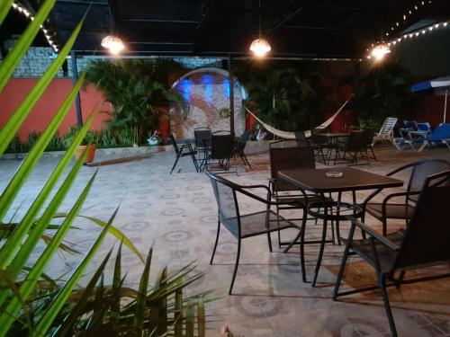 a group of tables and chairs in a patio at Hotel Lulu in Bucerías