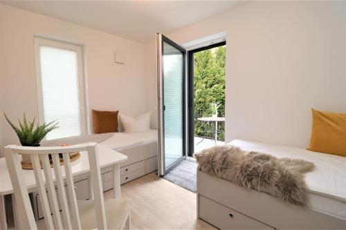 a bedroom with a bed and a desk and a mirror at Aquamarin Ostseetraumsuite 02 in Neuhaus