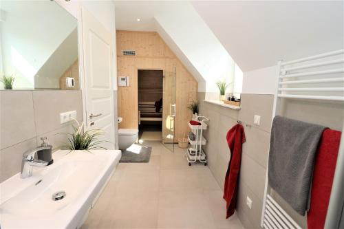 a bathroom with a sink and a mirror at Ferienhäuser Villa Ostseekind in Neuhaus