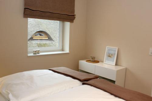 Ένα ή περισσότερα κρεβάτια σε δωμάτιο στο Strandvilla Birkenallee Haus Meerzeit
