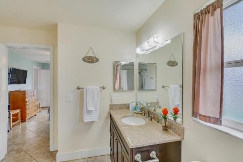 a bathroom with a sink and a mirror at Fun In The Sun: Canal Access in Cape Coral