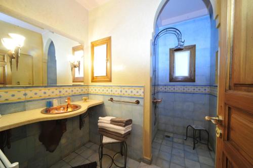 a bathroom with a sink and a shower at MAROC LODGE Atlas Mountain Retreat in Amizmiz