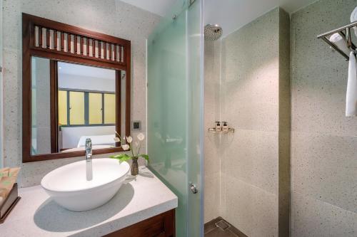 a bathroom with a white sink and a shower at Chillax Old Town Villa in Hoi An