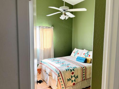 a bedroom with a bed and a ceiling fan at Wildflower Haven room in Hemet