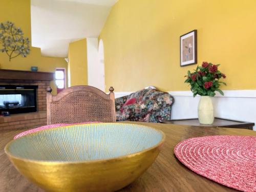 a bowl on a wooden table in a living room at Wildflower Haven room in Hemet