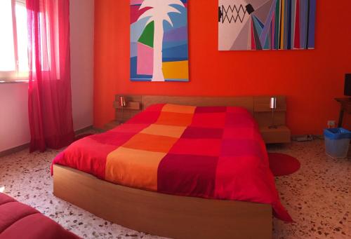 a bedroom with a bed with a colorful bedspread at B&B La Galleria in Palermo