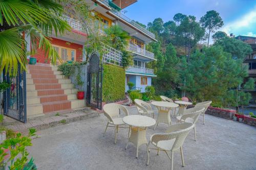 a group of tables and chairs in front of a building at Wow Homestay I Kasauli in Kasauli
