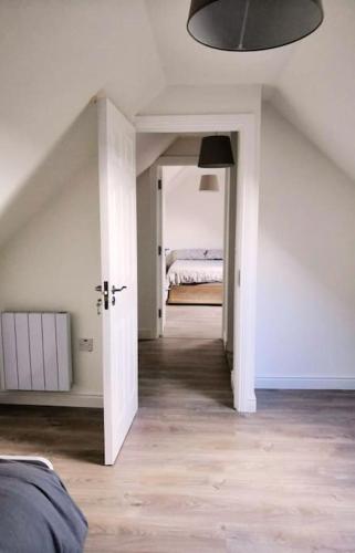 a room with a bedroom with a bed in it at Secluded Modern Guest House in Castletown Gheoghegan