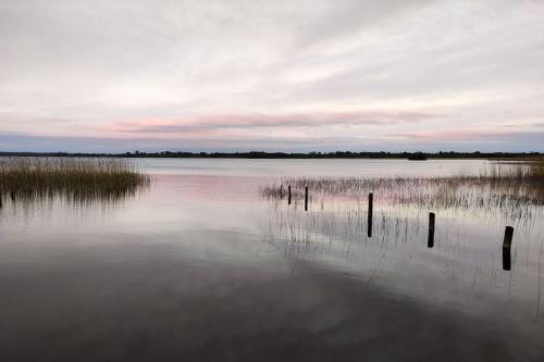 a large body of water with poles in the water at Secluded Modern Guest House in Castletown Gheoghegan