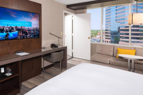 a hotel room with a bed and a flat screen tv at Durham Marriott City Center in Durham