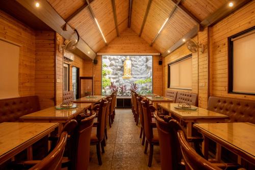 a dining room with wooden tables and chairs at M Square Hotel in Hyderabad