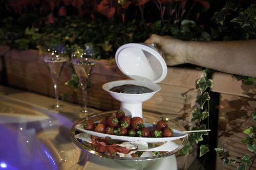 a plate of food with a bowl on top of a table at Hotel Bologna ***S in Verona