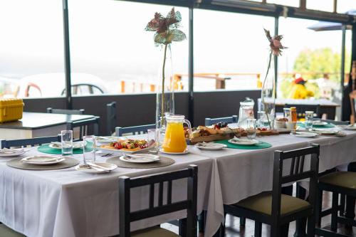 a table with plates of food and drinks on it at Issaquena Heights Boutique Hotel in Knysna