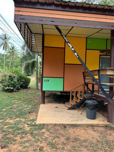 a house with a yellow and green paint on it at Fine Times Resort in Ko Chang