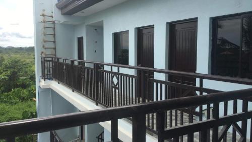 a balcony of a house with black railing at Donadel Hometel in Iloilo City