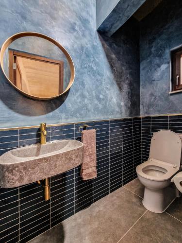 a bathroom with a sink and a mirror at Luxury Farmhouse Villa surrounded with Nature & Farm Animals Alpacas etc in Għasri