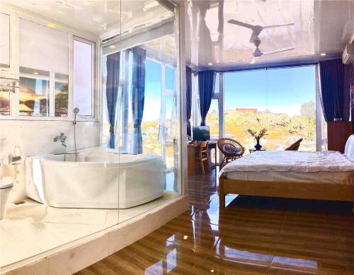 a large bathroom with a large tub and a bed at Starview Villa Dalat in Da Lat