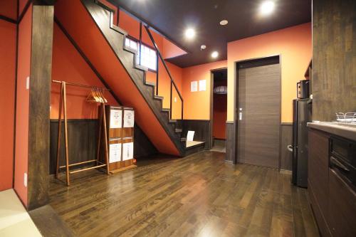 a large room with a staircase and a hallway at MUSUBI Sanjo Bettei in Kyoto