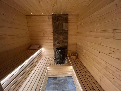 an empty wooden sauna with a stove in it at Boutique Hotel and Apartments Pension Sternen in Todtmoos