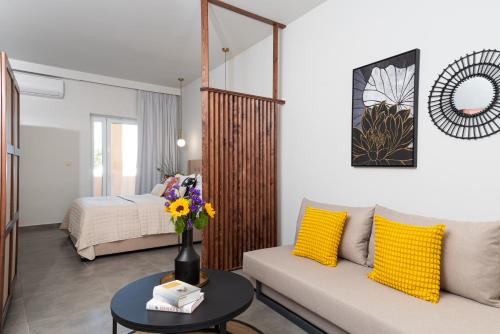 a living room with a couch and a bed at Meliora Suites in Drapaniás
