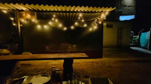 a bench in a restaurant with lights on it at M Cube Service Apartments in Sakleshpur