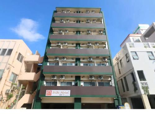 a tall building with balconies on the side of it at BiBi Hotel 泊ポート in Naha