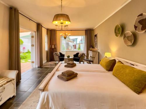 a bedroom with a large white bed in a room at Brigadoon Boutique Guesthouse in Swakopmund