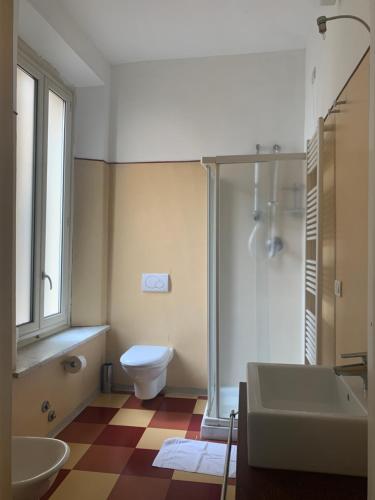 a bathroom with a toilet and a sink and a shower at Leon doro in Parma