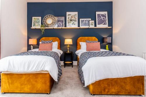 ダーリントンにあるBoho Chic - Stylish Home in City Centre, Sleeps 4の青い壁のドミトリールーム ベッド2台