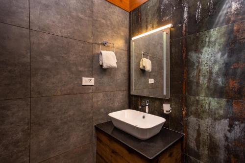 a bathroom with a sink and a mirror at Johns Village in Cochin