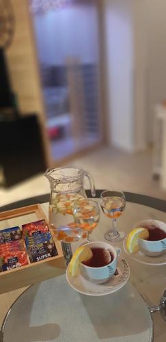 a table with glasses of water and a cup of tea at Mrežnički kutak in Duga Resa