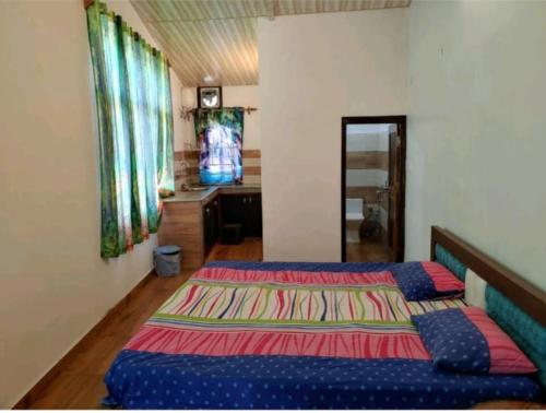 ビムタルにあるSunshine yellow Jungle cottageのベッドルーム1室(ベッド2台、ドレッサー付)
