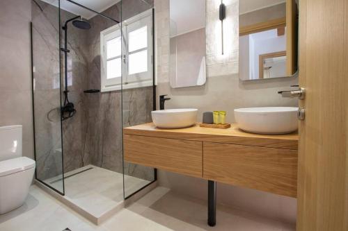 a bathroom with a sink and a shower at Angestrale Traditional Residence in Lefkada Town