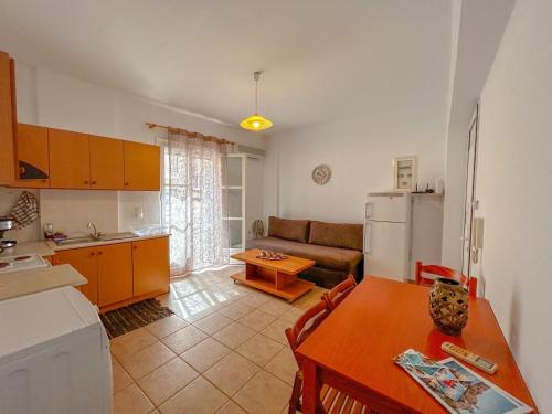 a kitchen and living room with a table and a couch at CENTRAL APARTMENTs in Ermoupoli