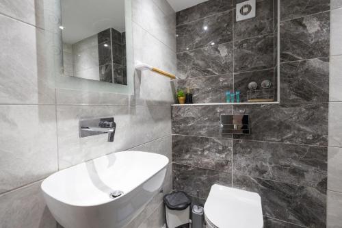 ein Badezimmer mit einem weißen Waschbecken und einem WC in der Unterkunft Alexandra Studios in Kallithea (Chalkidiki)
