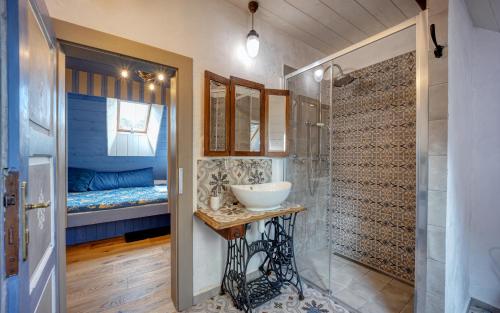 a bathroom with a sink and a bedroom with a bed at Statek Polzov in Polžov