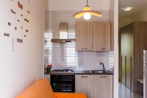 a kitchen with a sink and a stove top oven at SanvitoTour - Appartamenti Il Mulino in San Vito lo Capo