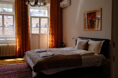 a bedroom with a bed and a window at Apartment Centrum in Novi Sad