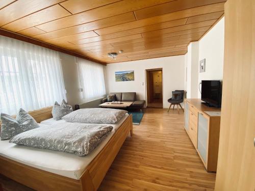 a bedroom with a bed and a living room at FEWO Vanessa in Willingen