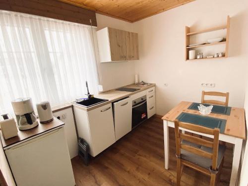 a small kitchen with a small table and a kitchen at FEWO Vanessa in Willingen