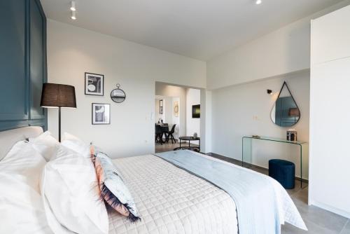 a bedroom with a large white bed with white pillows at Meliora Suites in Drapaniás