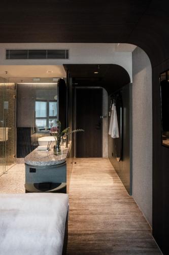 a bedroom with a bed and a sink in a room at Hillwood House Hotel in Hong Kong