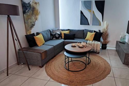 a living room with a couch and a table at Niki`s Luxury Apartment in Makry Gialos