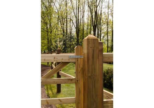 a wooden fence with a gate in a garden at Vakantiehoeve 'De Zandrug' in Stekene