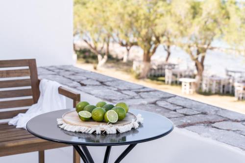 a plate of limes on a table on a patio at Eden Kythira in Dhiakofti